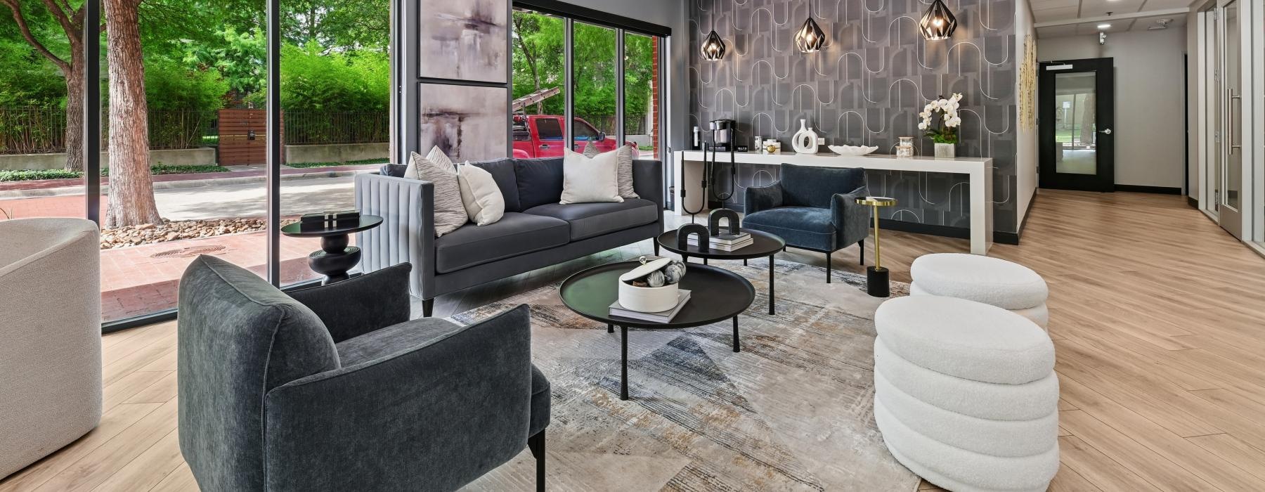 a lounge room with a couch and large glass wall