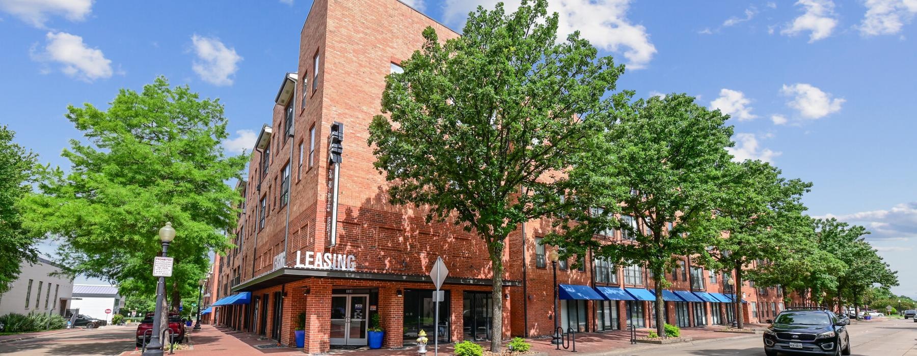 a car parked in front of a brick building