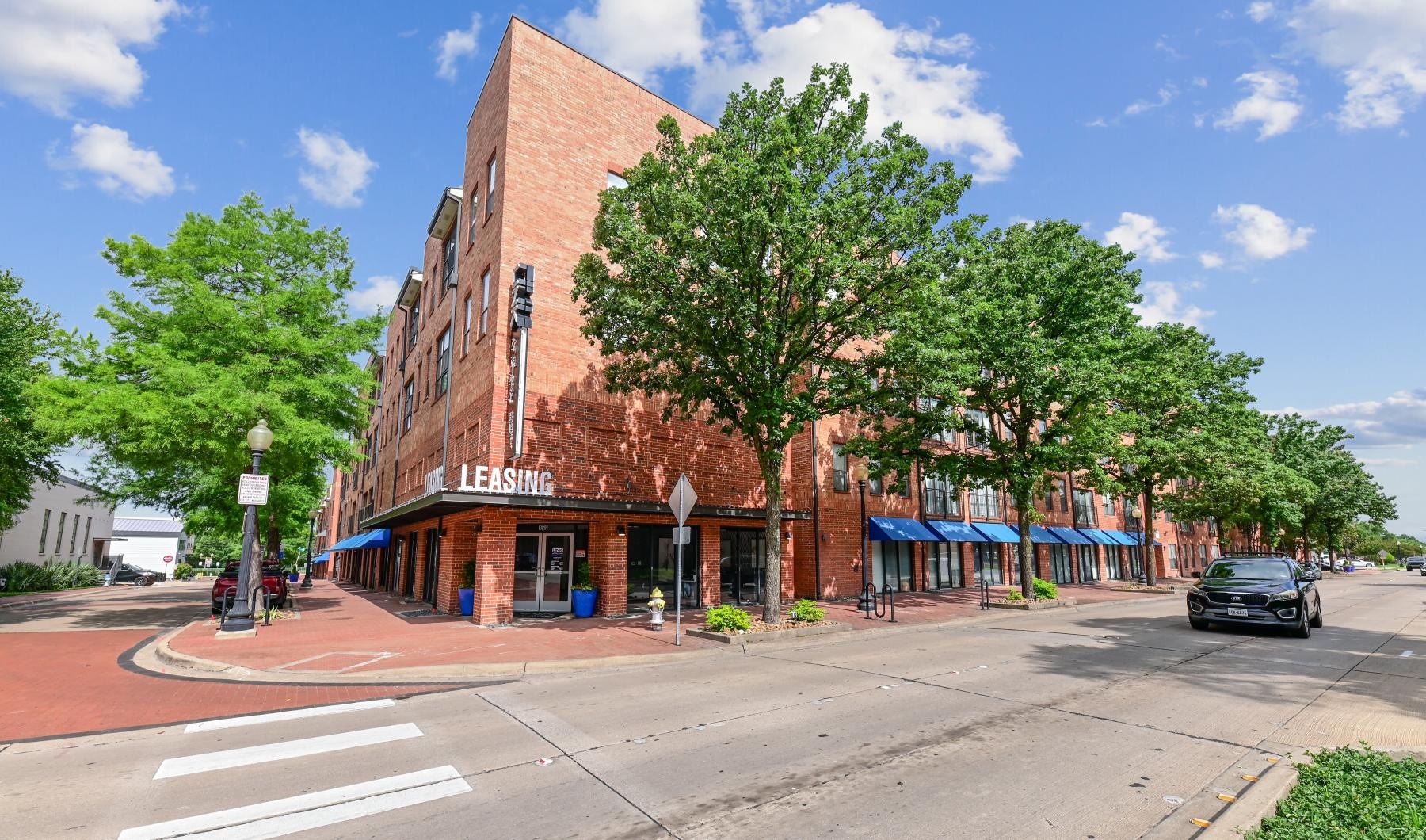 a car parked in front of a brick building