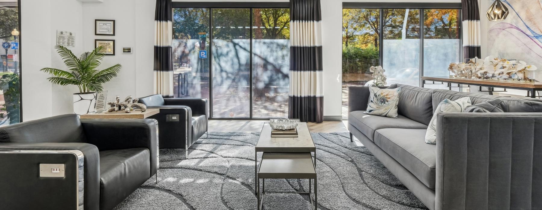 a living room with a couches and large window